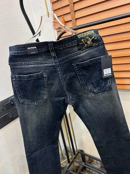 TRUE RELIGION IMPORTED POCKET HEAVY EMBROIDERED BOOT CUT DENIM*